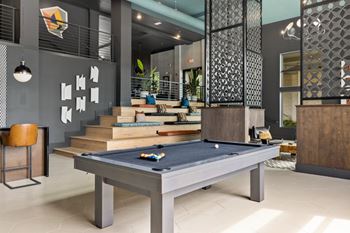Gaming lounge with billiards, foosball, shuffleboard, and vintage arcade games